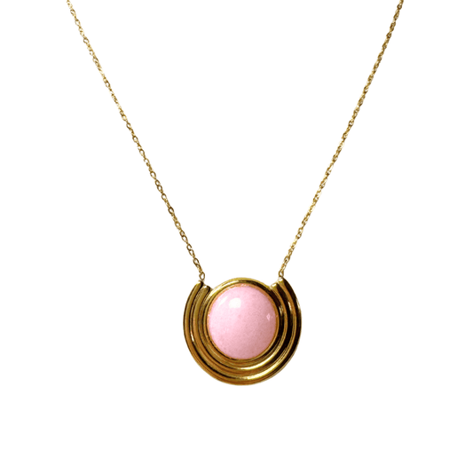 Necklace with a pink pendant on a gold chain against a white background