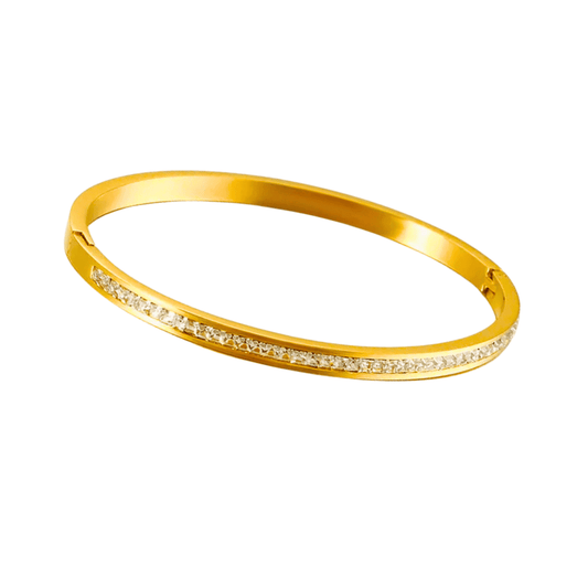 Gold bracelet with small diamonds on a white background