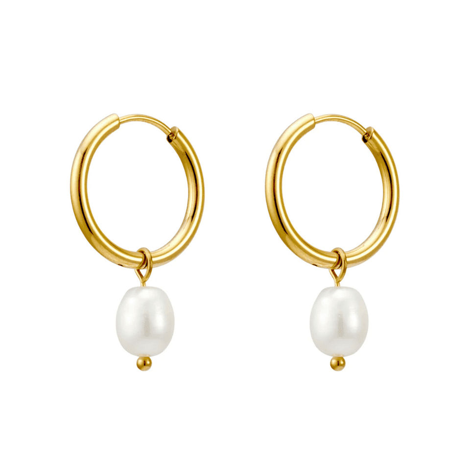 Gold hoop earrings with white pearls on a white background