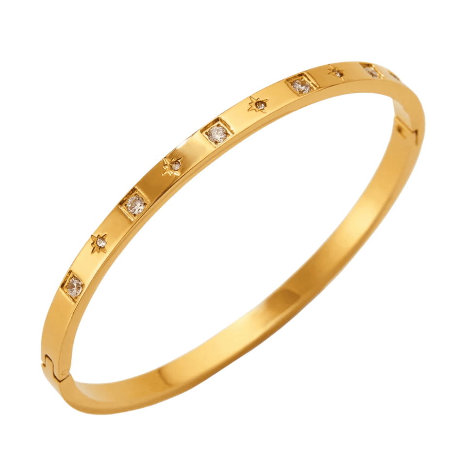 Gold bracelet with embedded diamonds on a white background
