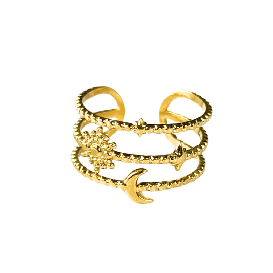 Gold ring with star, moon, and anchor designs on a white background
