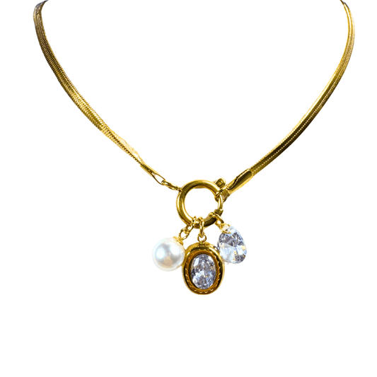 Gold necklace with charms on a white background
