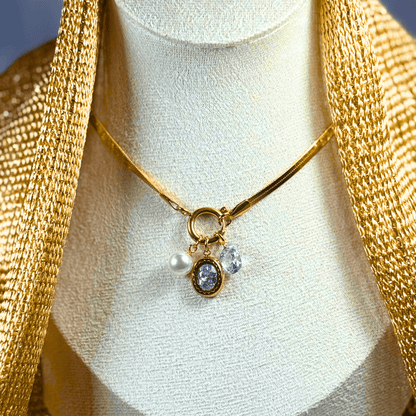 Gold necklace with a pendant on a mannequin bust
