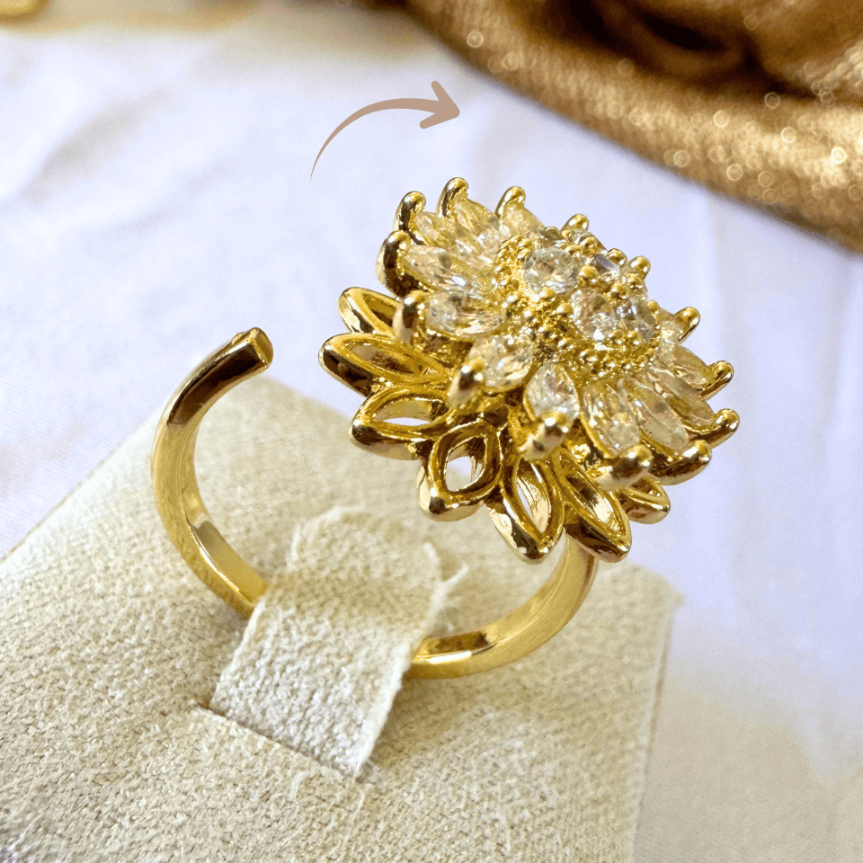 Gold ring with floral design on a white background