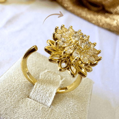 Gold ring with floral design on a white background