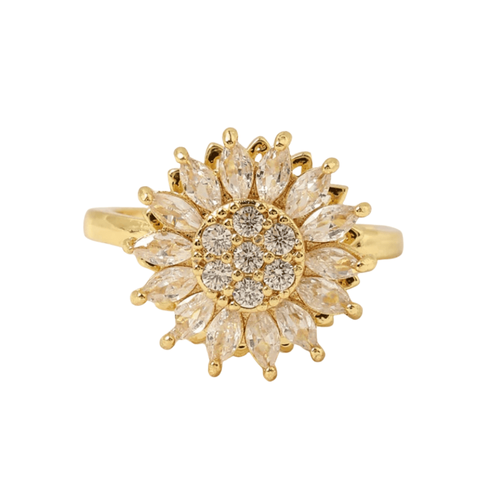 Gold ring with diamond-like stones on a white background