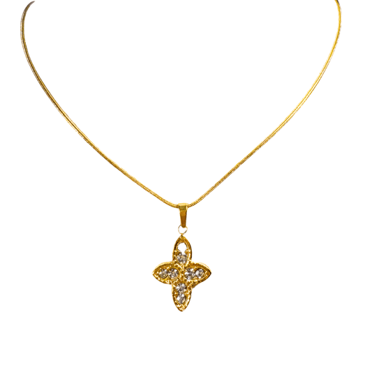 Gold necklace with a star-shaped pendant on a white background