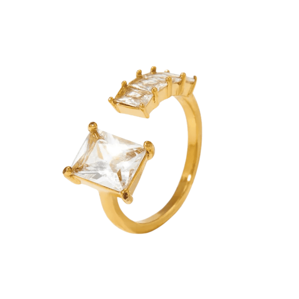 Gold ring with square-cut gemstones on a white background