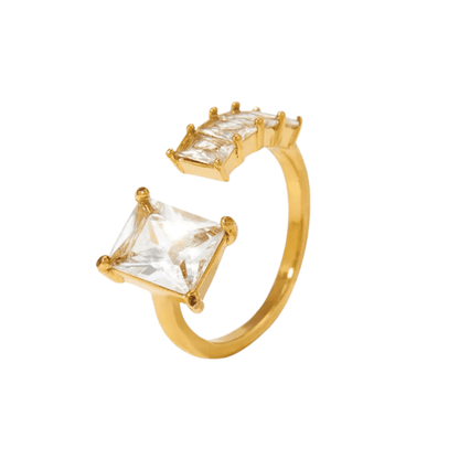Gold ring with square-cut gemstones on a white background