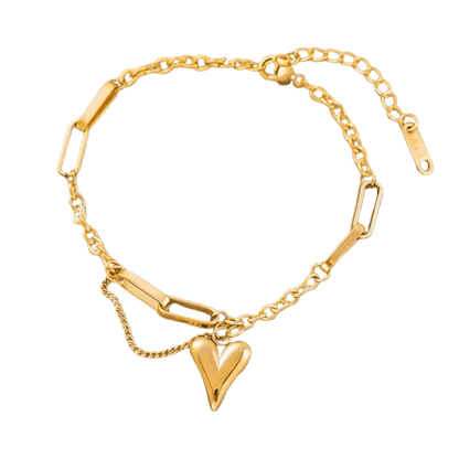 Gold bracelet with a heart charm on a white background