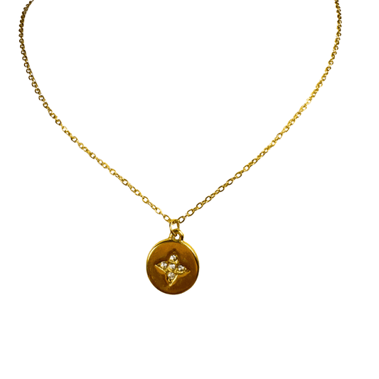 Gold necklace with a round pendant on a white background