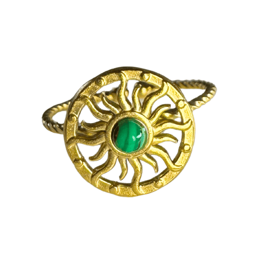 Gold ring with a green gemstone on a white background