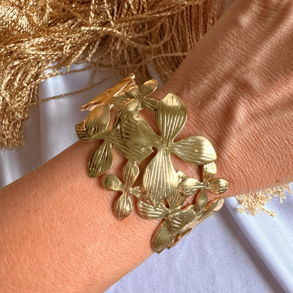 Gold leaf bracelet on a wrist with a light background