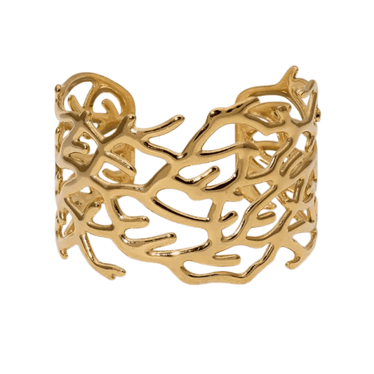 Gold branch-like bracelet on a white background