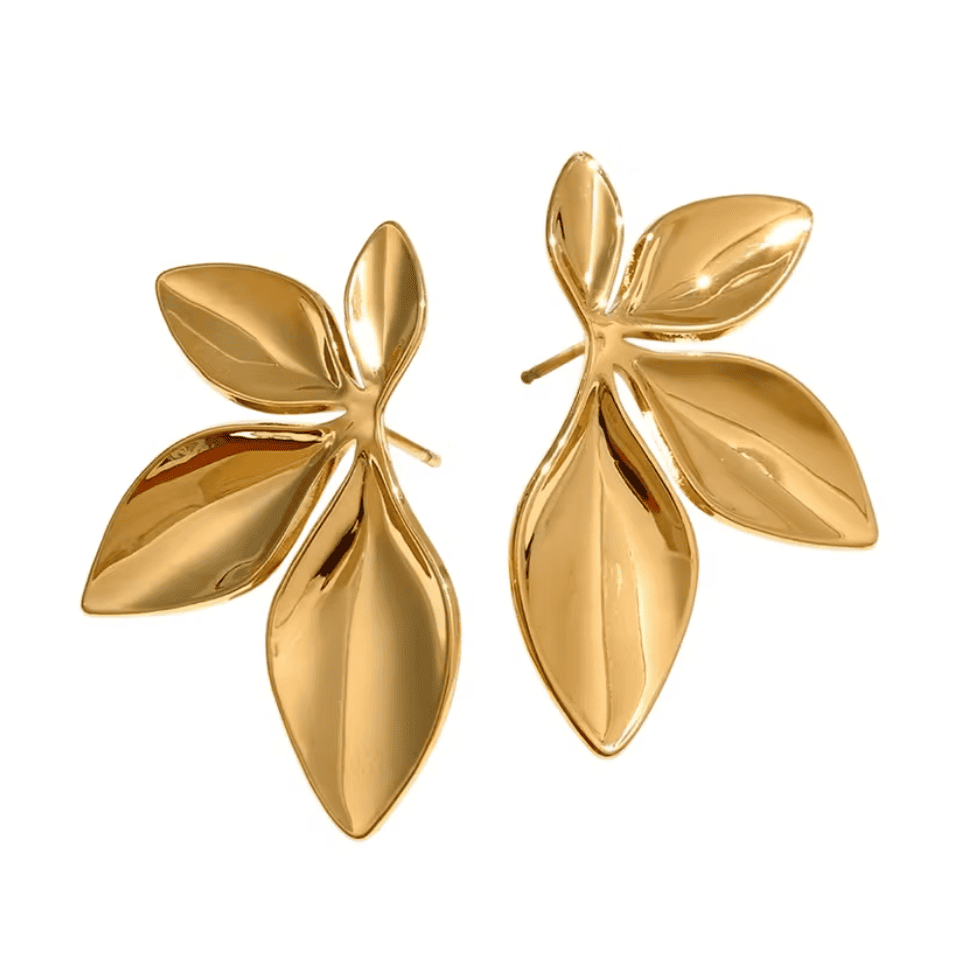 Pair of gold leaf-shaped earrings on a white background