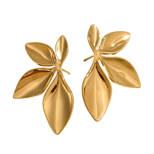 Pair of gold leaf-shaped earrings on a white background