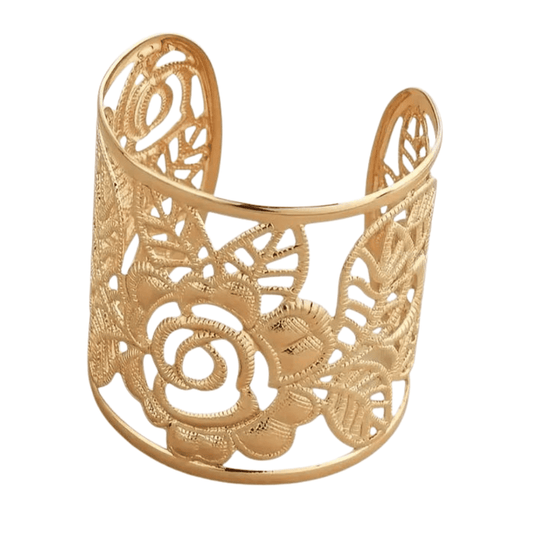 Gold filigree cuff bracelet on a white background