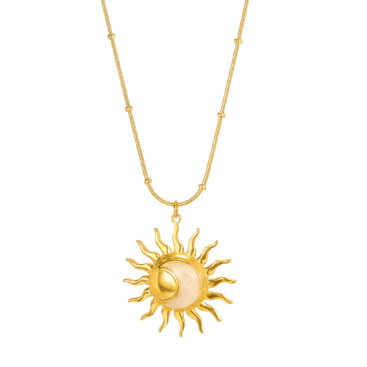 Gold sun-shaped pendant necklace on a white background