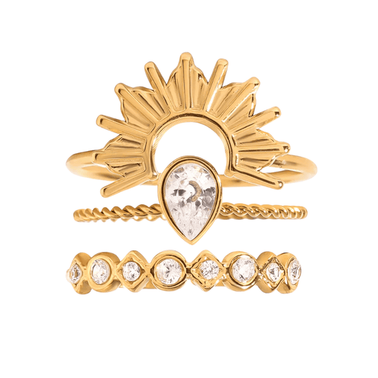 Set of gold rings with gemstones on a white background