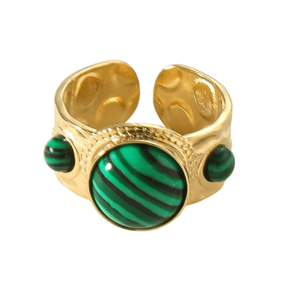 Gold ring with green stone on a white background