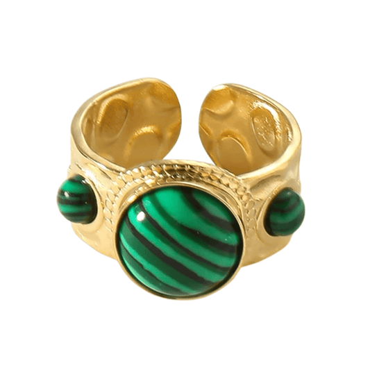 Gold ring with green stone on a white background