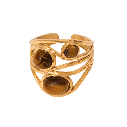 Gold ring with three brown gemstones on a white background