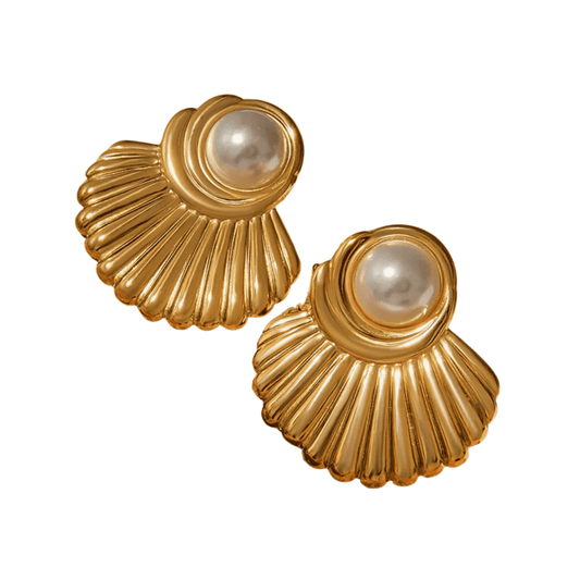 Gold earrings with pearl centers on a white background