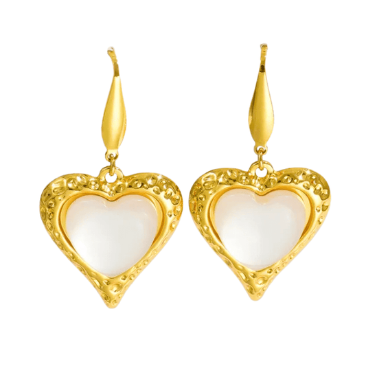 Gold heart-shaped earrings with white centers on a white background