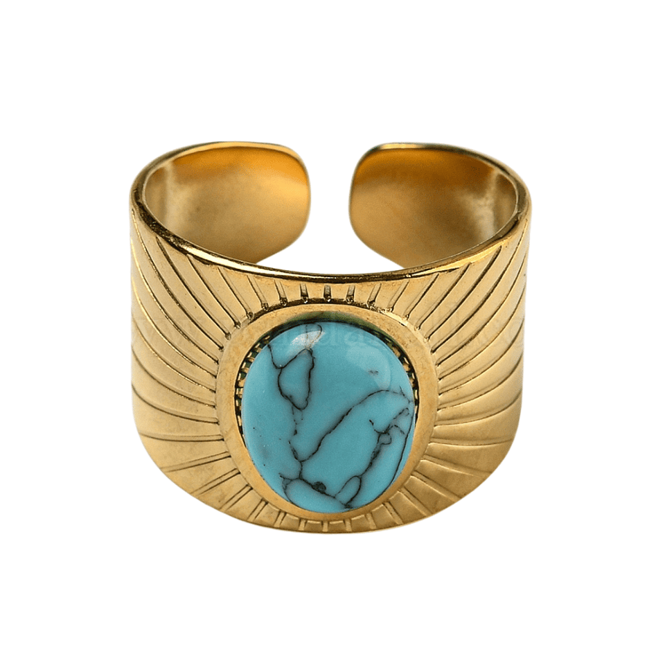 Gold cuff bracelet with a turquoise stone on a white background