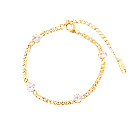 Gold bracelet with clear gemstones on a white background