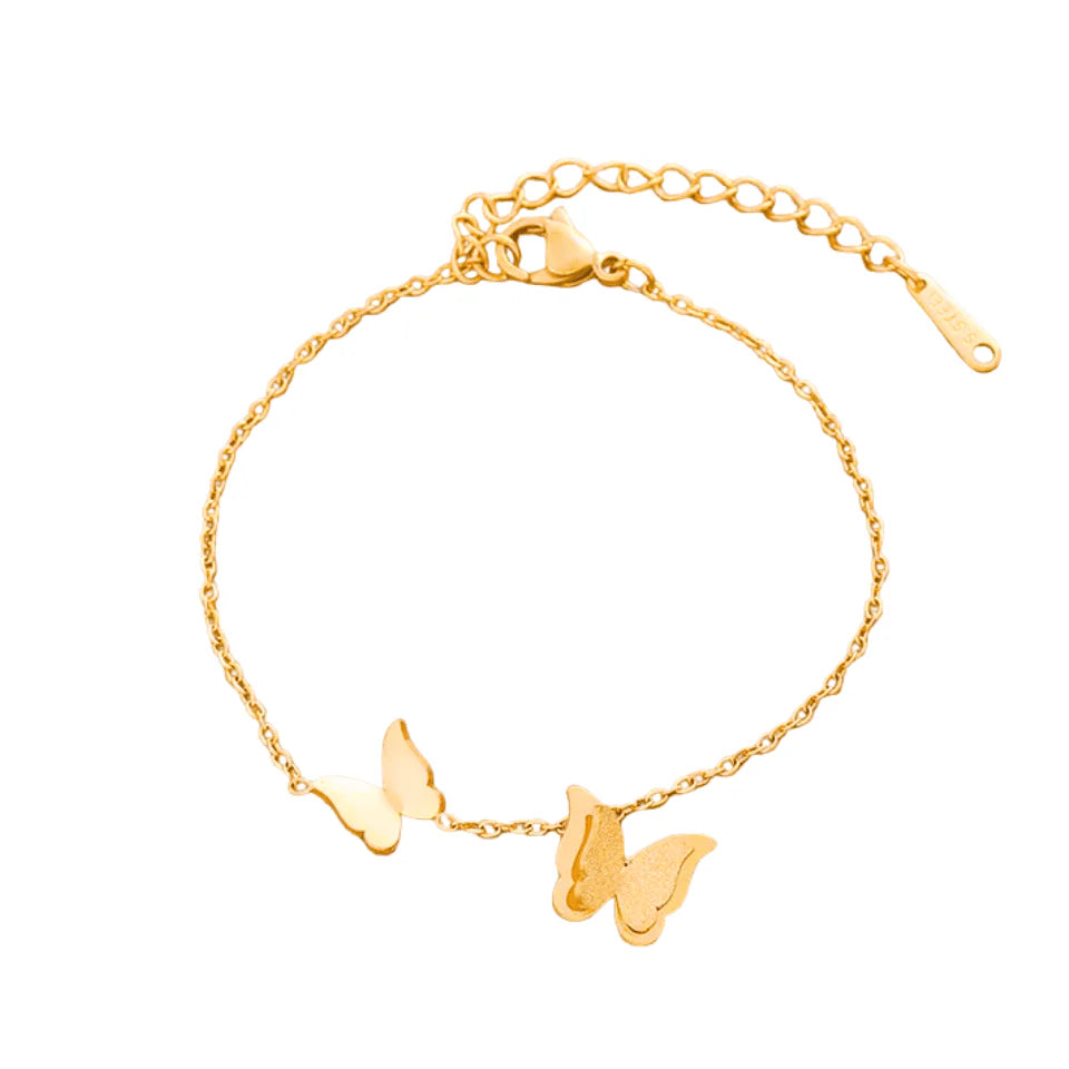 Gold bracelet with butterfly charms on a white background