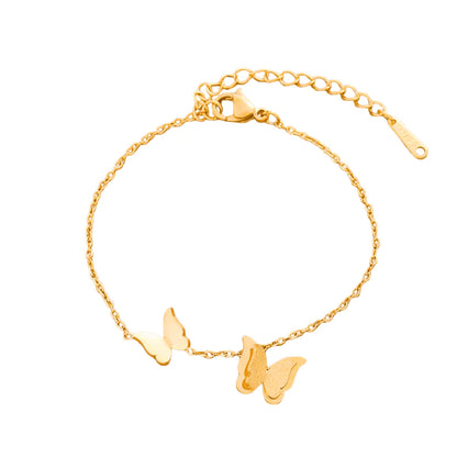 Gold bracelet with butterfly charms on a white background