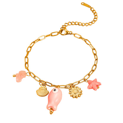 Gold bracelet with pink shell, starfish, and flower charms on a white background