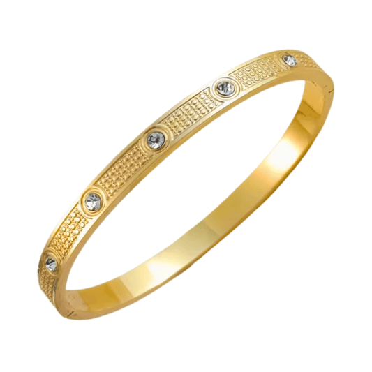 Gold bracelet with embedded crystals on a white background